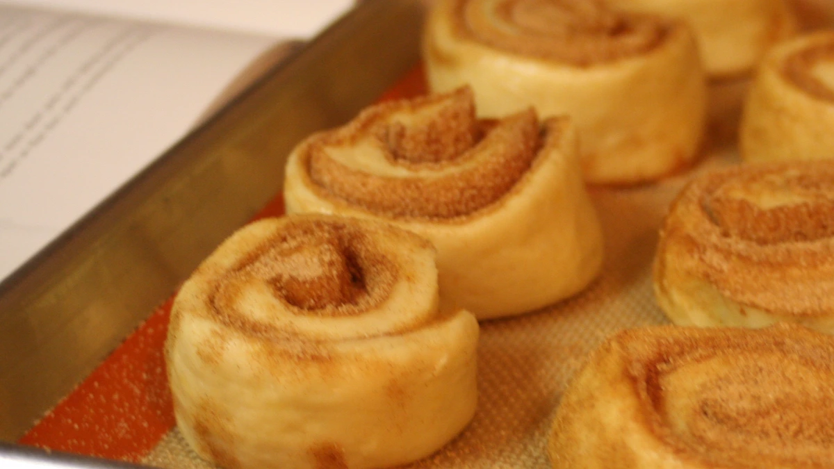Cinnamon rolls on a lined baking tray, the kind of treat a nursing unit shares when a nurse is honored