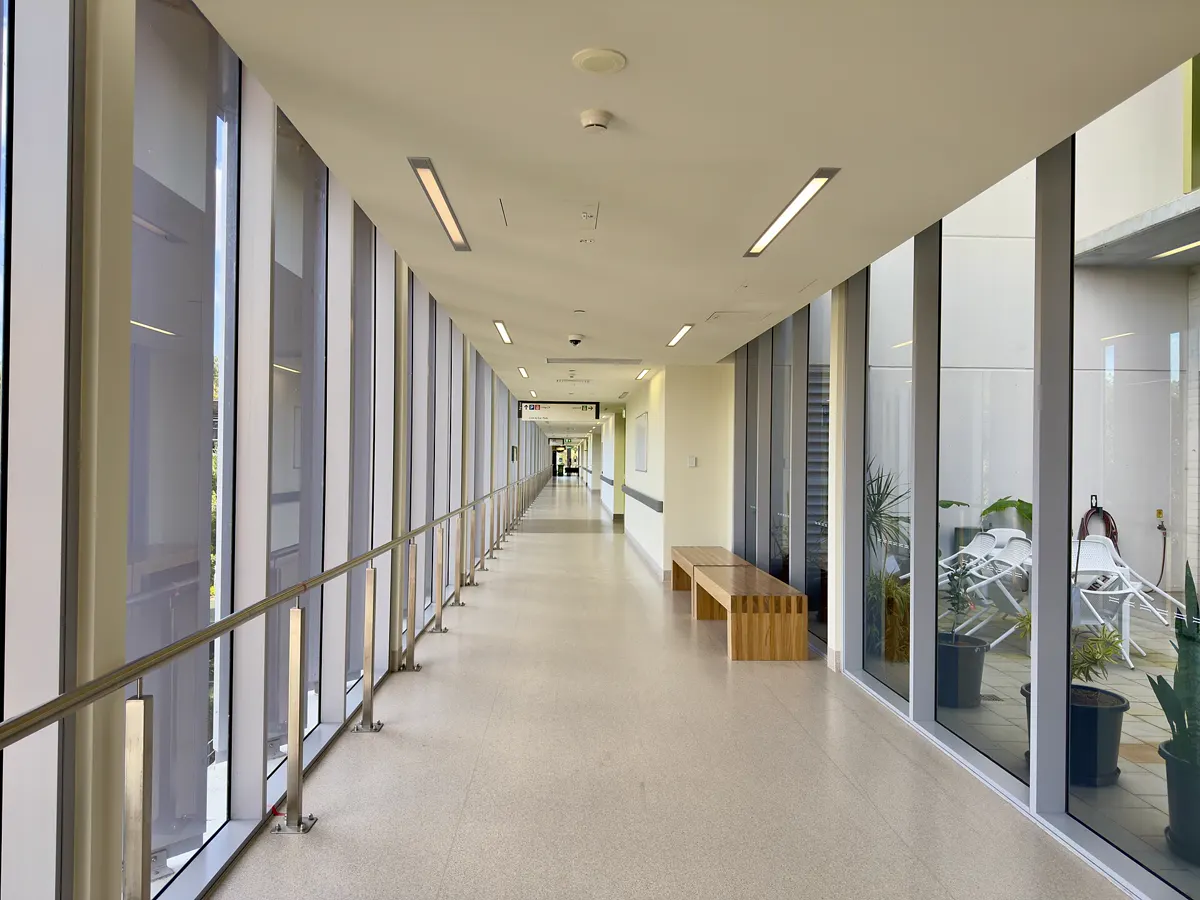 Long, quiet hospital corridor with windows along one side at Nambour General Hospital